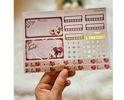 Sheet of decorative stickers with hearts, numbers, and text held by a hand against a blurred background.