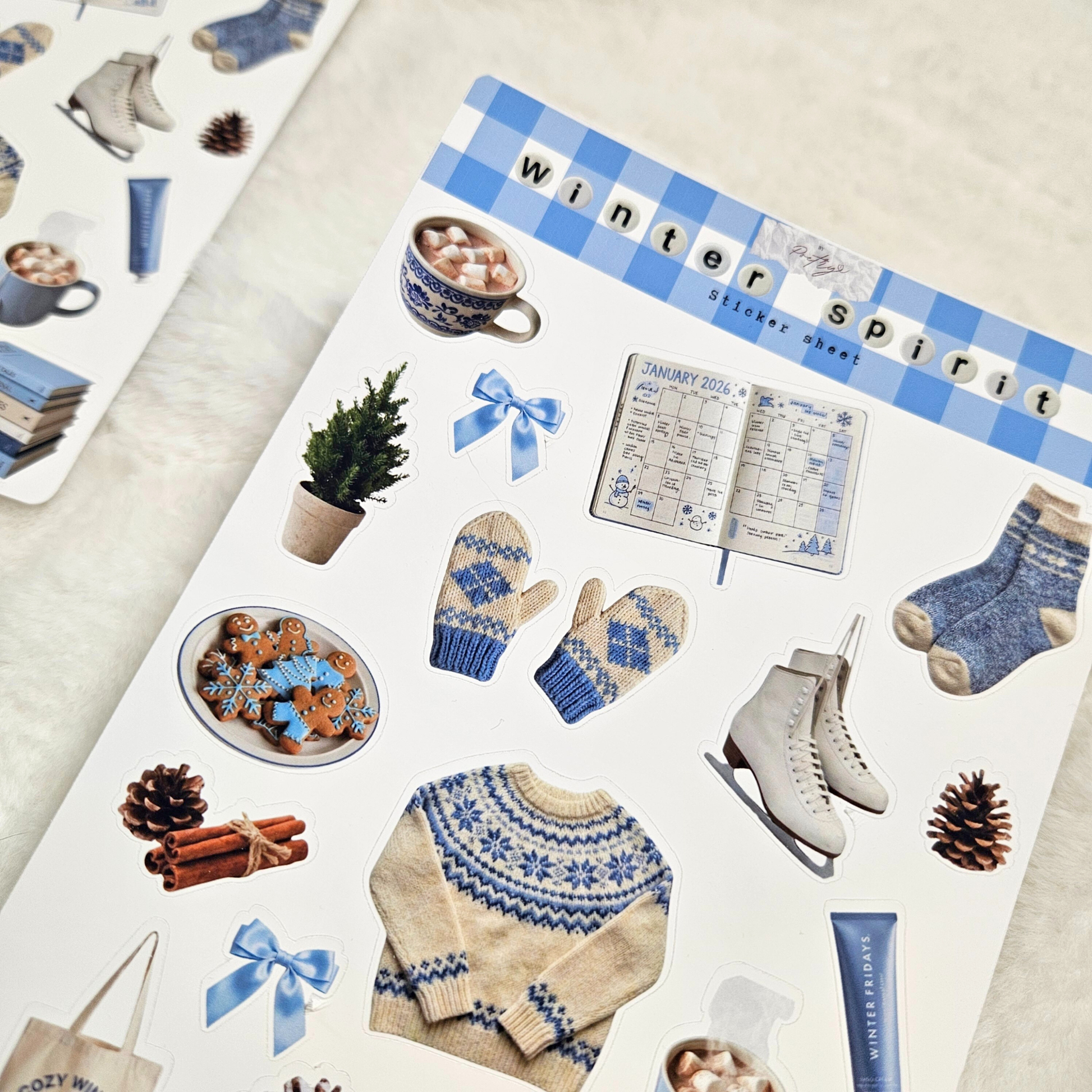 Sheet of 'Winter Spirit' stickers with winter-themed items on a light background