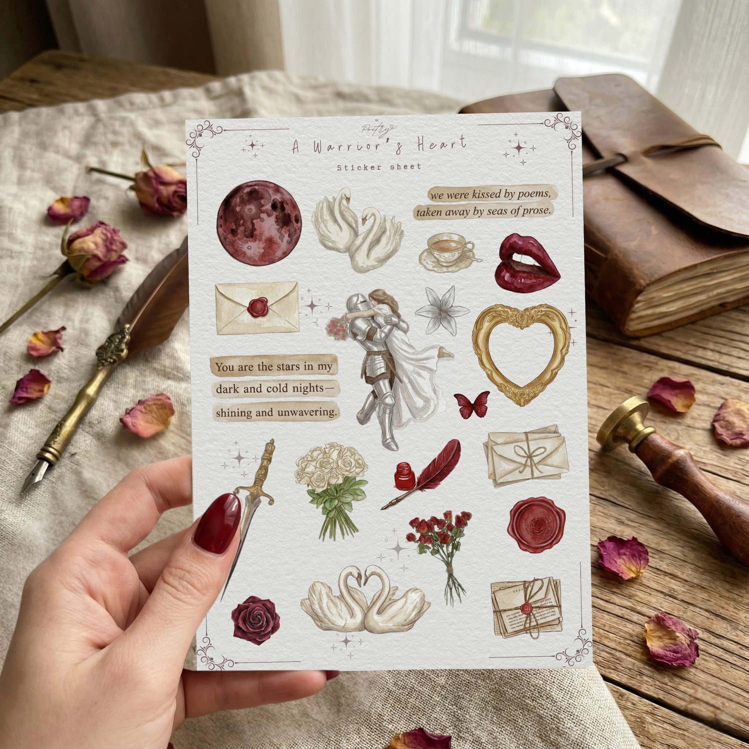 Hand holding the 'A Warrior's Heart' Valentine's Day sticker sheet in a cozy, rustic setting. The sheet contains watercolor stickers of swans, roses, a knight, and love letters